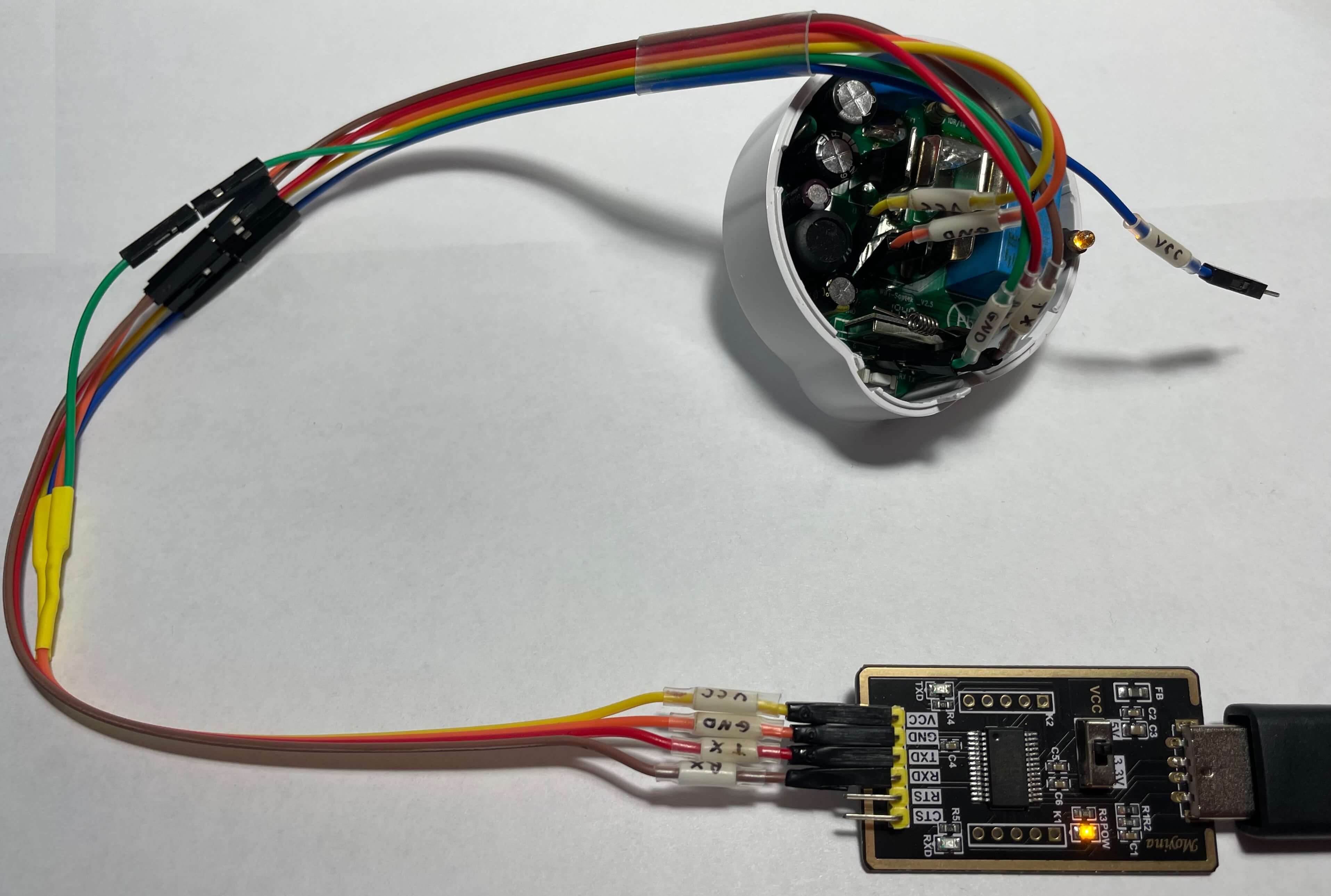 Etekcity Voltson ESW01-USA-R6P Connected to a USB serial converter and Booted into Flash Mode An angled view of the Etekcity Voltson ESW01-USA-R6P connected to a USB serial converter as described in the table above and booted into Flash Mode.
